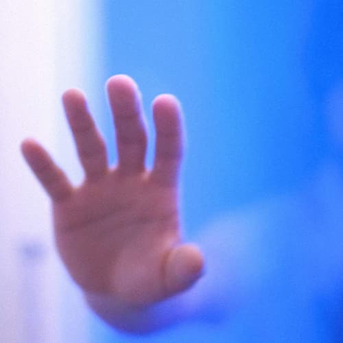 A scene of the Clara Mem movie with a hand towards the screen and a blue background